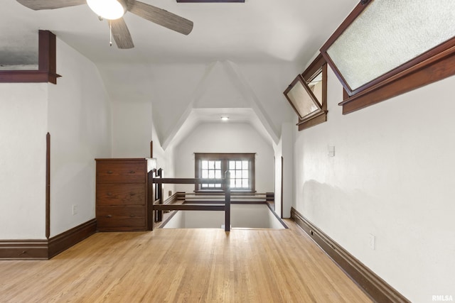 bonus room with vaulted ceiling and light hardwood / wood-style floors