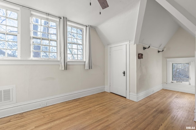 additional living space with vaulted ceiling, light hardwood / wood-style floors, and ceiling fan