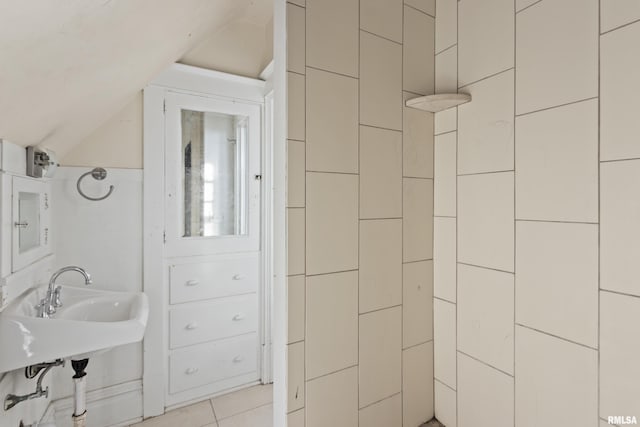 bathroom with tile patterned flooring and vaulted ceiling