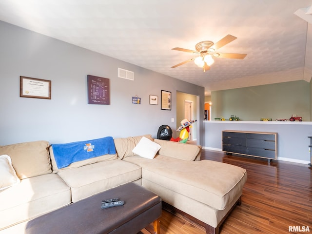 living room with ceiling fan and dark hardwood / wood-style flooring