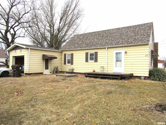 rear view of property featuring a lawn