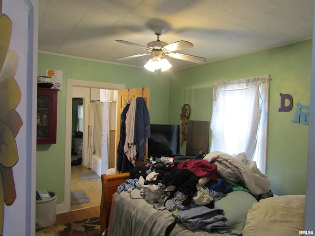 bedroom featuring crown molding, ceiling fan, and hardwood / wood-style floors