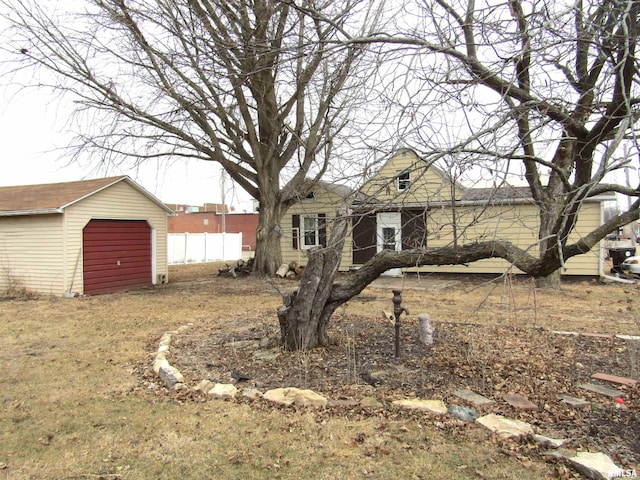 view of front of house with a garage and an outdoor structure