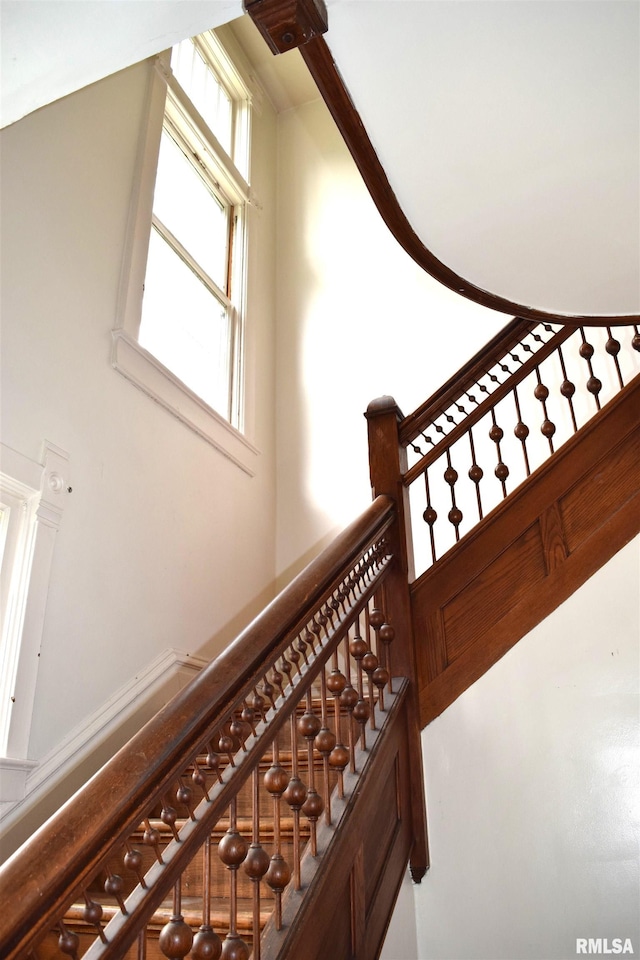 stairs featuring a towering ceiling