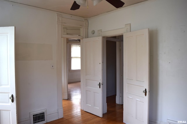 empty room with ceiling fan and hardwood / wood-style floors