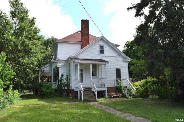 exterior space featuring a lawn and a porch