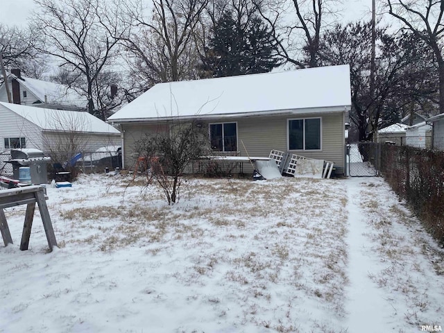 view of snow covered rear of property