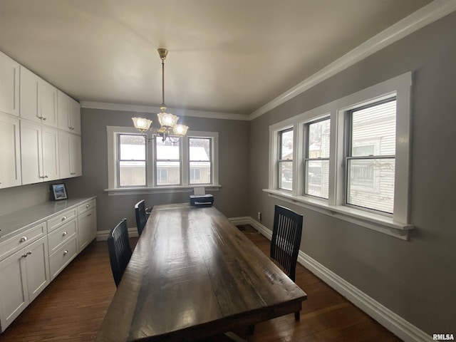 dining space featuring ornamental molding, dark hardwood / wood-style floors, and a chandelier