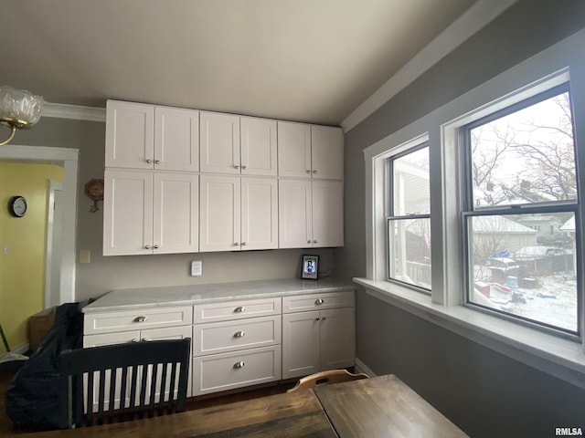 kitchen with dark hardwood / wood-style flooring and white cabinets