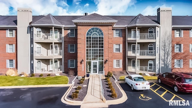 view of property featuring uncovered parking