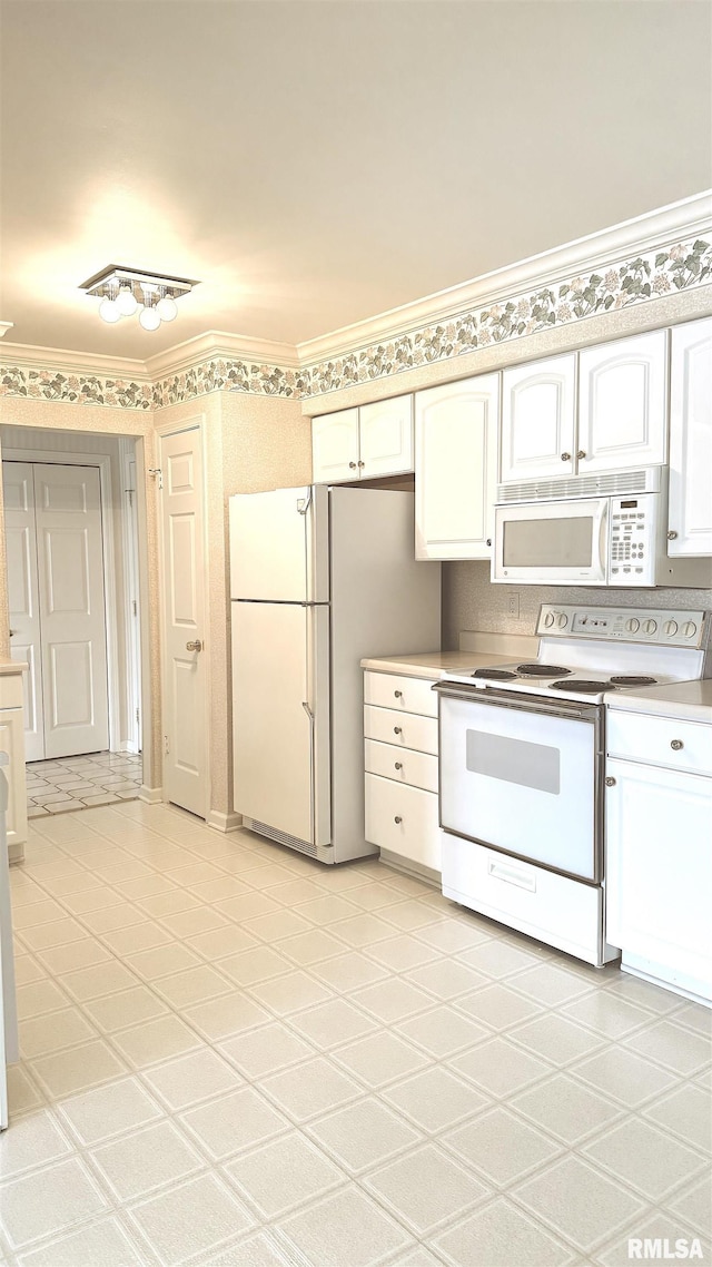 kitchen featuring ornamental molding, light countertops, white appliances, and white cabinets