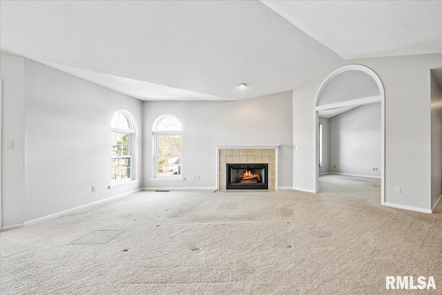 unfurnished living room with baseboards and light colored carpet