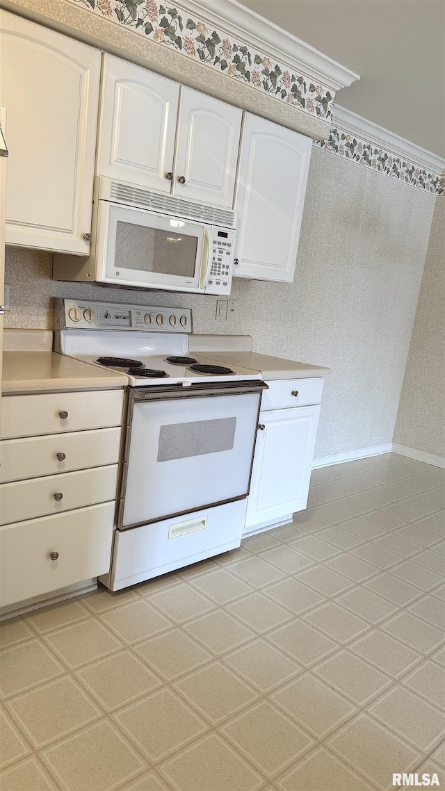 kitchen with white appliances, baseboards, white cabinets, light countertops, and ornamental molding