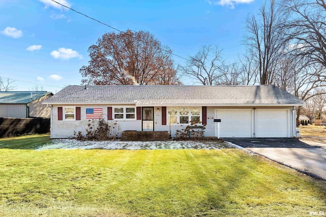 ranch-style house with a garage and a front lawn