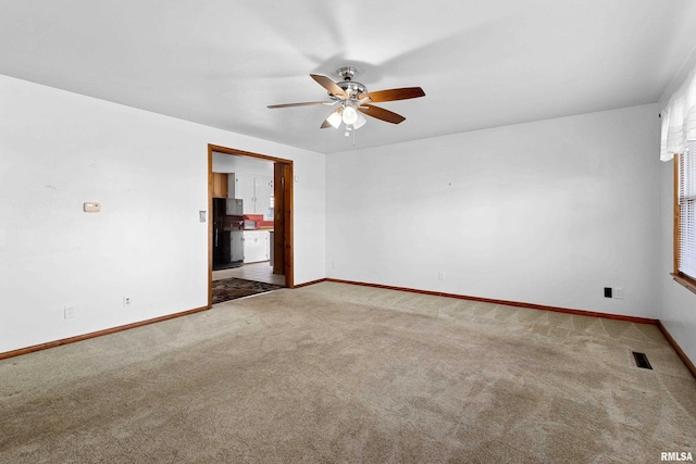 empty room with ceiling fan and carpet flooring