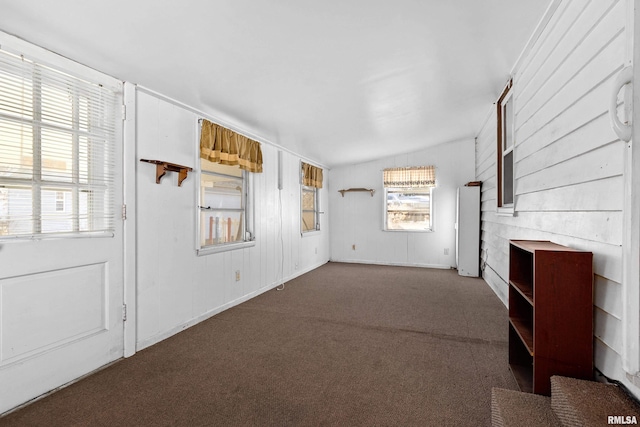 unfurnished living room featuring lofted ceiling and carpet floors