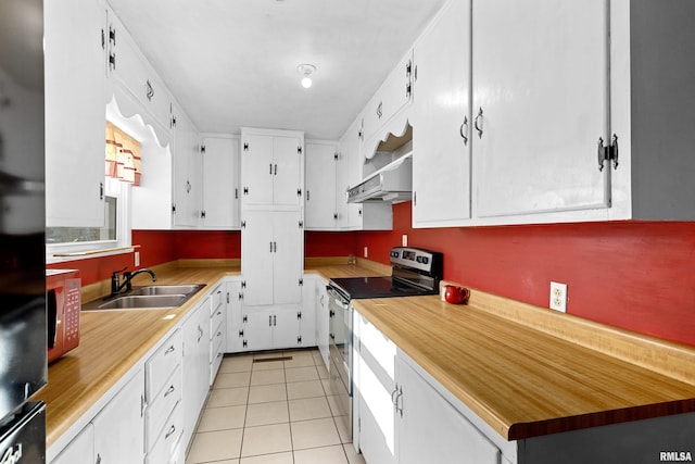 kitchen featuring sink, white cabinetry, light tile patterned floors, fridge, and stainless steel electric stove