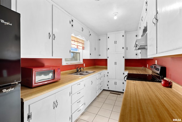 kitchen with white cabinetry, stainless steel range with electric stovetop, refrigerator, and sink