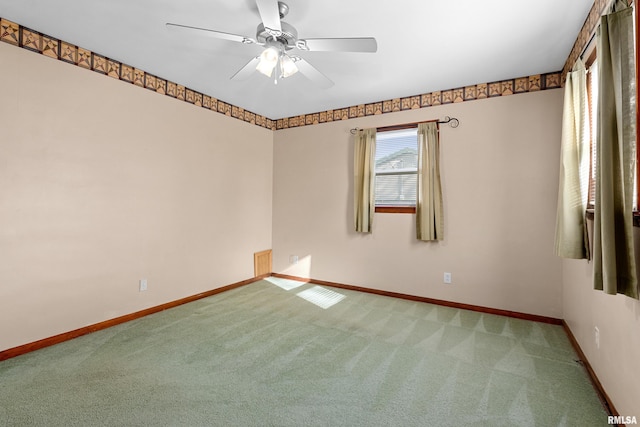 empty room with ceiling fan and carpet floors