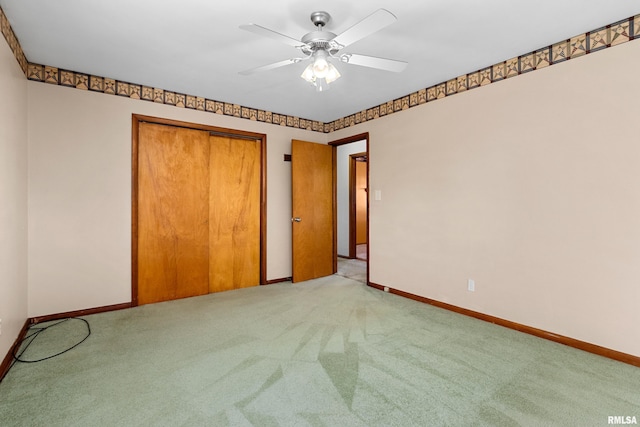 unfurnished bedroom with light carpet, ceiling fan, and a closet