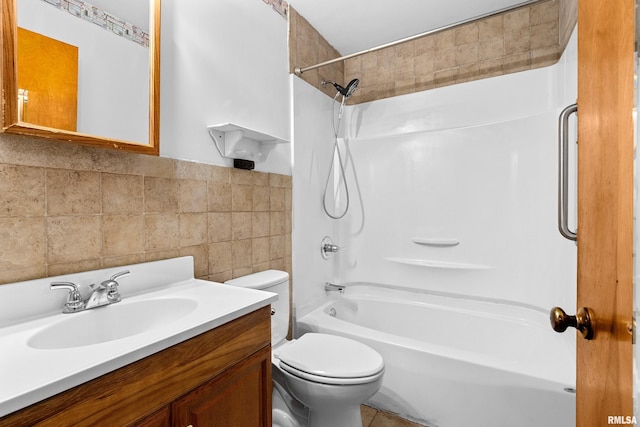 full bathroom with tile walls, vanity, bathing tub / shower combination, and toilet