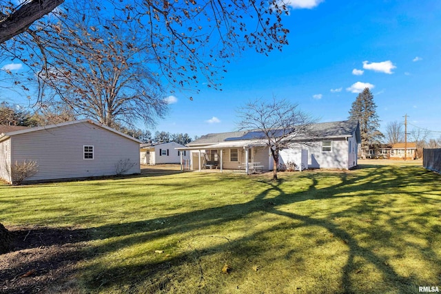 rear view of house with a lawn