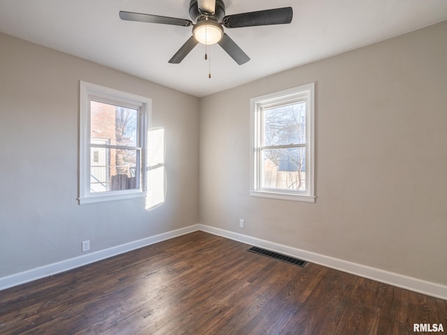 unfurnished room with plenty of natural light, dark hardwood / wood-style floors, and ceiling fan