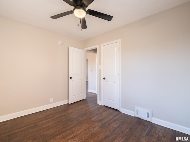 unfurnished room featuring dark hardwood / wood-style flooring and ceiling fan