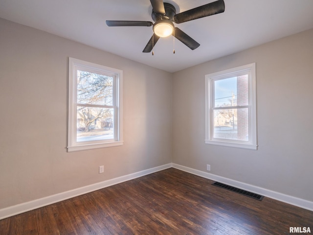 spare room with dark wood-type flooring and ceiling fan