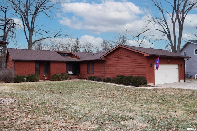 ranch-style house with a garage and a front yard