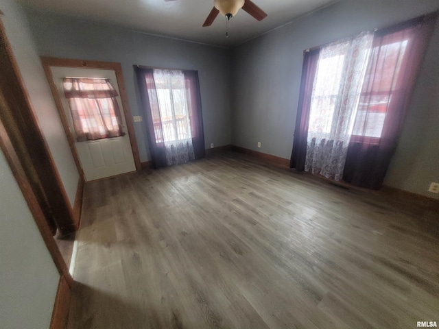 empty room featuring hardwood / wood-style flooring and ceiling fan