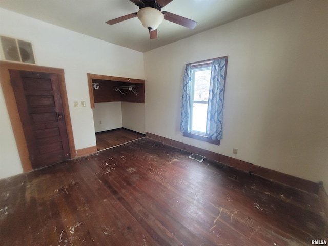 unfurnished bedroom featuring dark wood-type flooring and ceiling fan