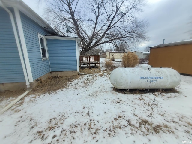 yard layered in snow featuring a wooden deck