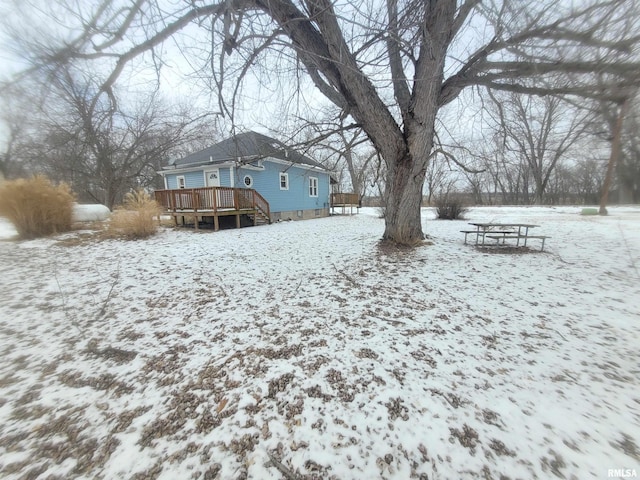 yard covered in snow featuring a wooden deck