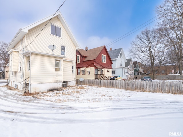 view of snow covered rear of property