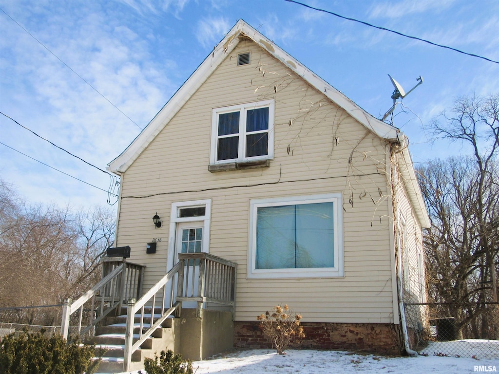 bungalow-style home with fence