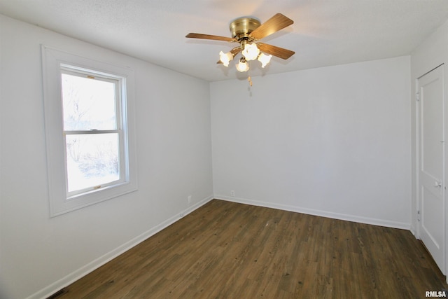 spare room with ceiling fan and dark hardwood / wood-style flooring