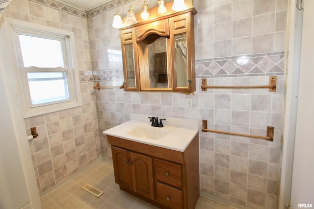 bathroom featuring tile walls and vanity