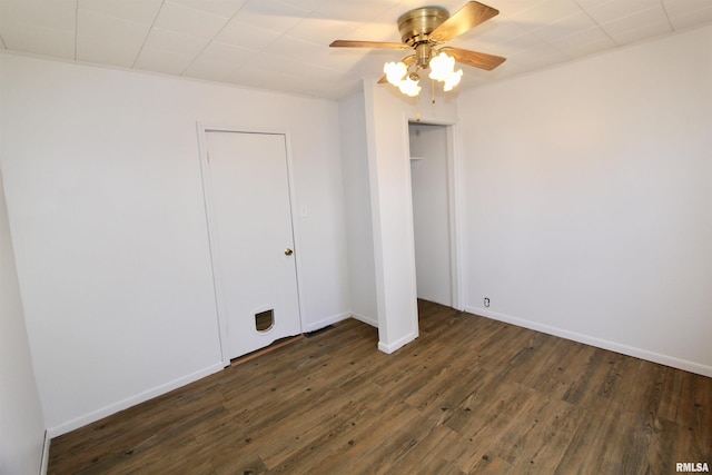 unfurnished bedroom with ceiling fan, dark hardwood / wood-style floors, and a closet