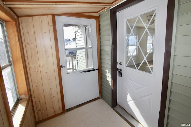 entryway featuring wooden walls