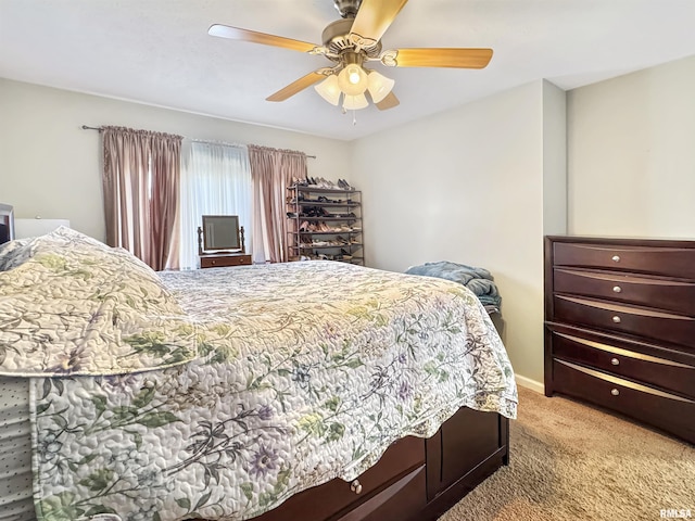 bedroom with light carpet and ceiling fan