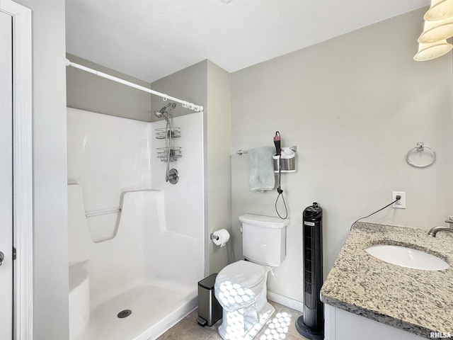 full bathroom with toilet, vanity, baseboards, a shower stall, and tile patterned floors