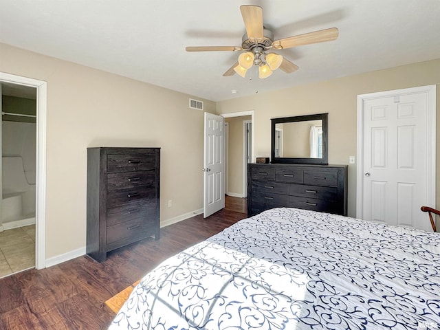 bedroom with a ceiling fan, visible vents, dark wood finished floors, and baseboards