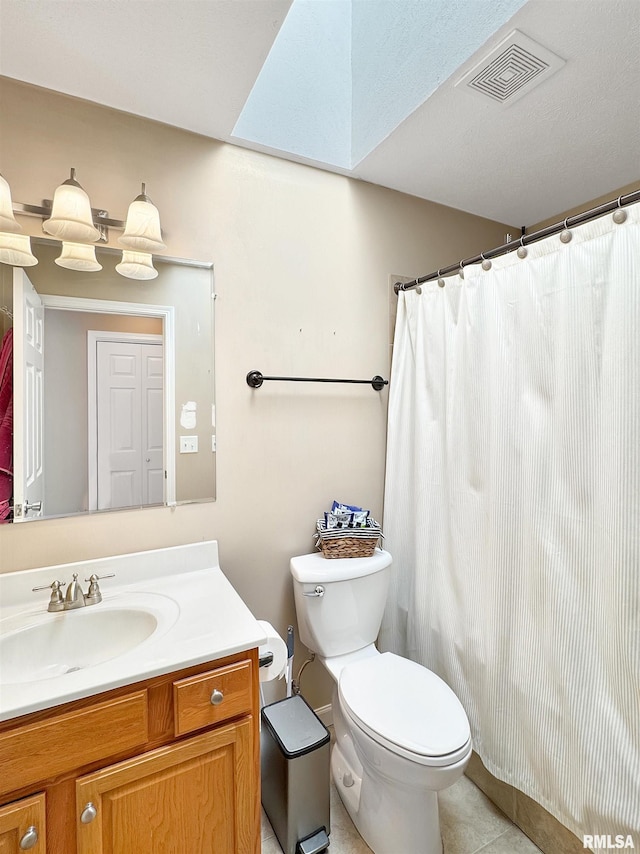 bathroom featuring tile patterned flooring, visible vents, vanity, and toilet