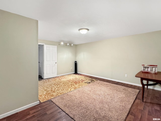 interior space with baseboards and wood finished floors