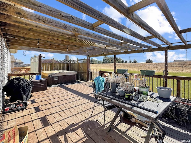 wooden deck featuring a hot tub, fence, and a pergola