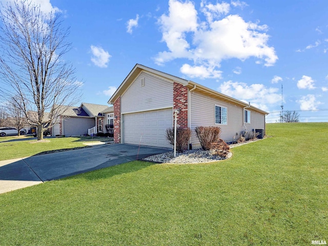 view of side of property with aphalt driveway, brick siding, a lawn, and an attached garage