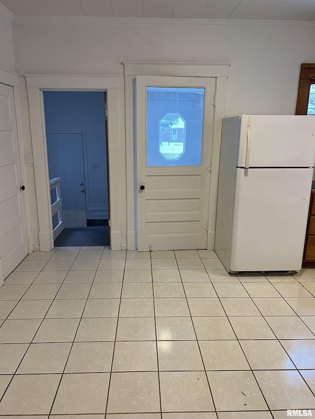 entrance foyer with ornamental molding and light tile patterned flooring