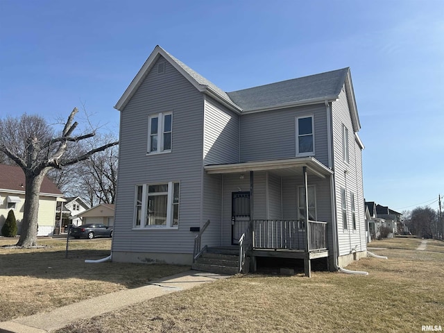 traditional-style home featuring a front lawn