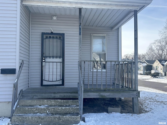 view of snow covered property entrance